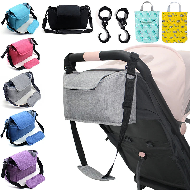 Gray stroller organizer with various colorful bags and accessories on a white background