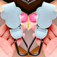 Light blue carabiner with black clip held by a hand against a neutral background
