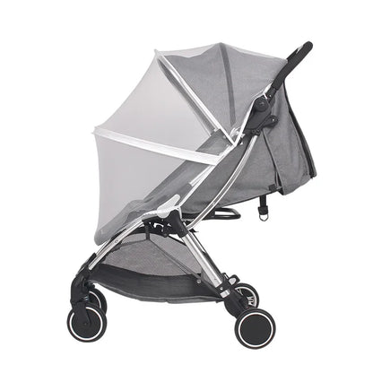 Gray stroller with a mesh canopy on a white background