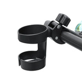 Black baby stroller cup holder attached to a strollerframe on a white background