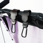 Black stroller hooks attached to a stroller with a white background