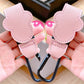 Pink cat-shaped hooks held by a person with a blurred background