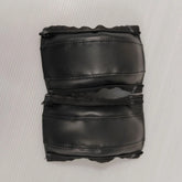 Pair of black leather stroller handle covers on a white background