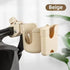 Beige cup holder attached to a stroller with a blurred background