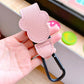 Pink leather strap with a black clip held in a hand on a blurred background
