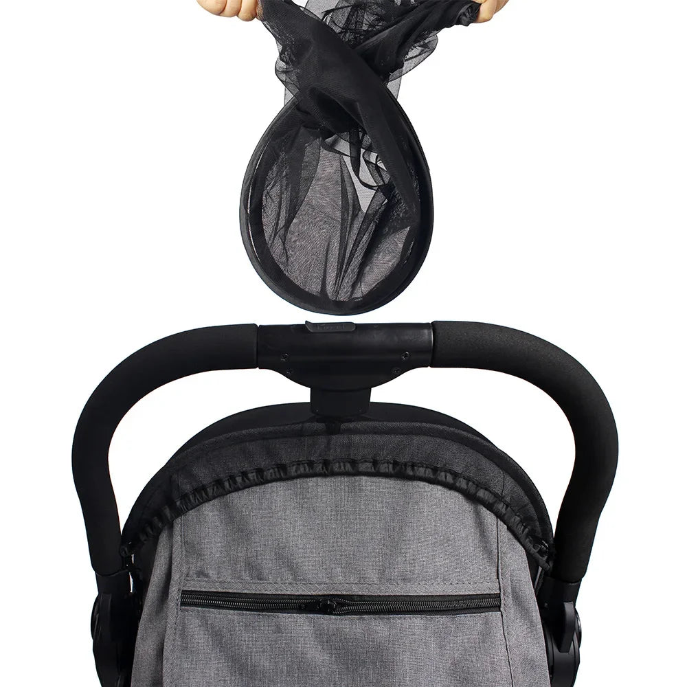 Close-up of a baby car seat with a mesh cover on a white background