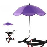 Purple umbrella attached to a stroller on a white background