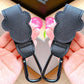 Black leather keychain carabiners held in hands with a blurred background